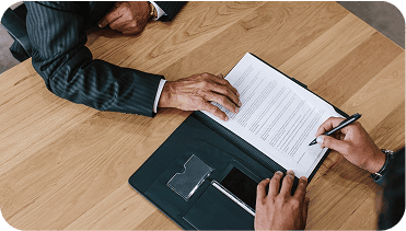 Professional website creator working on website content planning and design with a notebook and pen on a wooden desk.