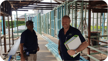 Construction workers inspecting framing of a building under construction in Australia.