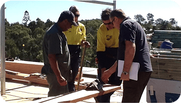 Professionals working on a website construction project outdoors, focused on planning and collaboration.