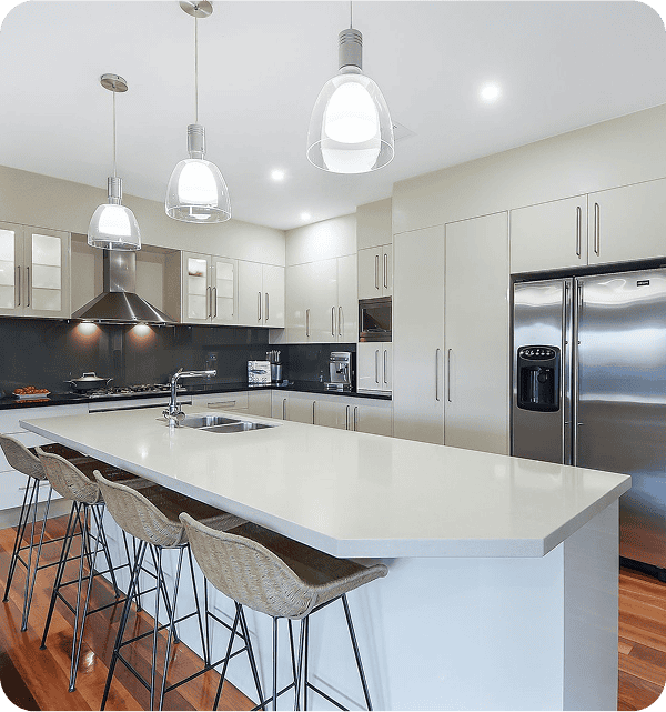 Modern kitchen with white cabinetry, stainless steel appliances, and a large island for cooking and entertaining, ideal for website creators showcasing contemporary home designs.