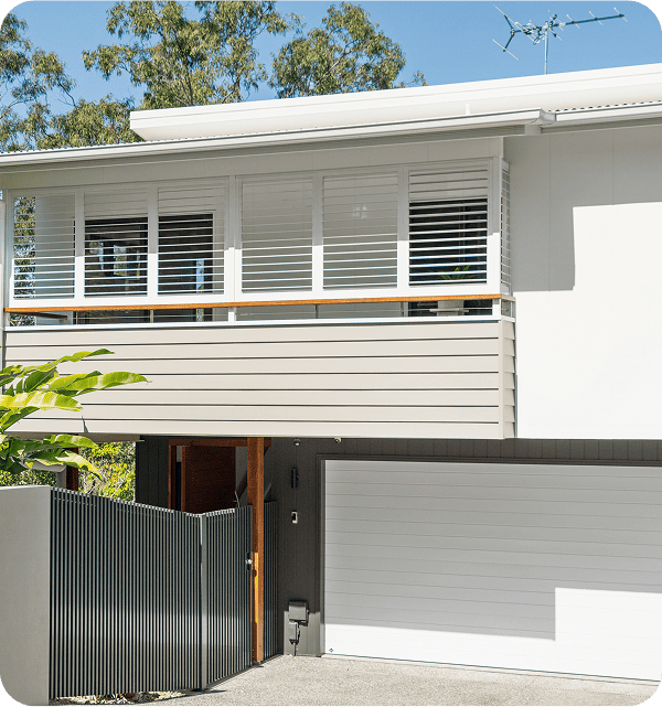 Modern Brisbane home with sleek balcony design and white exterior, showcasing contemporary architectural style with clean lines and minimalistic features for stylish living.