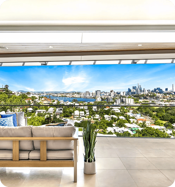 Balcony with city skyline view and modern furniture in Brisbane, Australia, showcasing a stylish outdoor living space with a scenic urban landscape background.