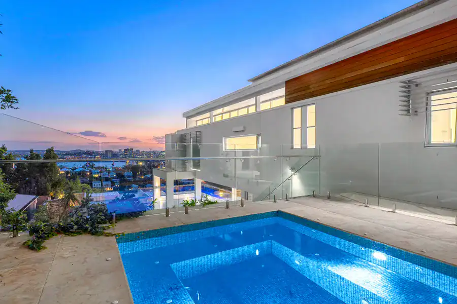 Modern luxury home with rooftop pool and city skyline views, showcasing contemporary architecture and outdoor living design. Perfect for creating stunning websites for real estate or luxury property businesses.