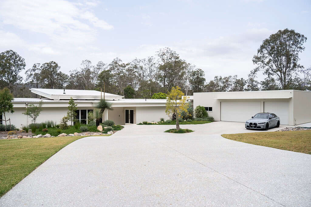 Modern contemporary house with sleek exterior design and landscaped garden, showcasing custom home building and housing construction services by McVeigh Homes in Australia.