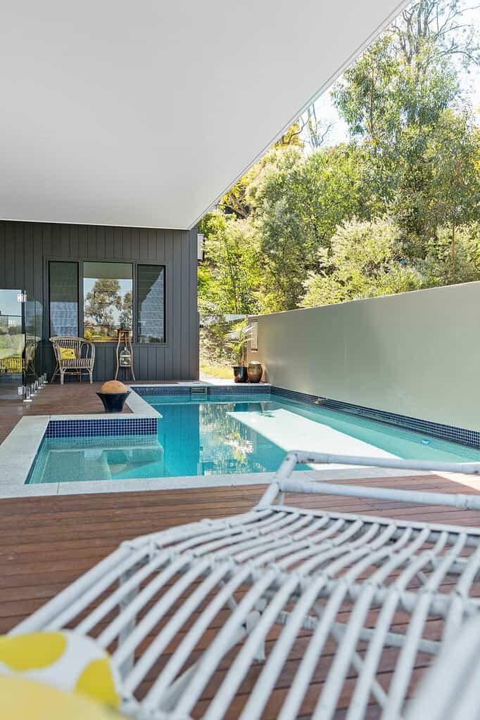 Modern residential home with an outdoor swimming pool, featuring stylish deck area and contemporary architecture. Perfect for luxury outdoor living and entertaining in Australia.